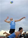 With Todd Rogers watching, American Phil Dalhausser serves the Mikasa during an opening elimination Friday on Glenelg Beach in the Adelaide Australia Open